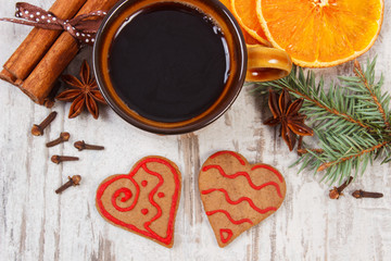 Fresh gingerbread, cup of coffee and spices on old wooden background, christmas time