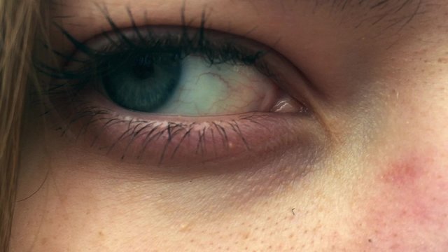 open female blue eye in 1080p a beautiful girl staring into the camera