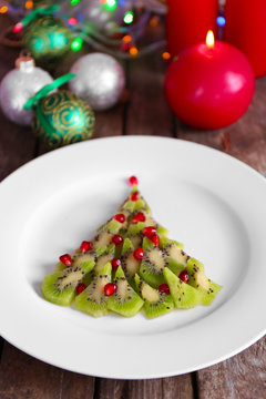 Christmas fir tree made from kiwi, on plate, close up