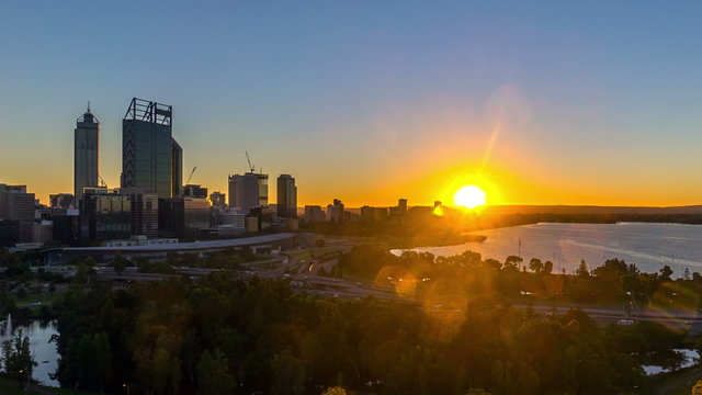 Time lapse Footage of beautiful dramatic Sunrise At Perth City, Australia. Taken from Kings Park And Botanic Garden. Showing a clear sun rise from the horizon line. Zoom in