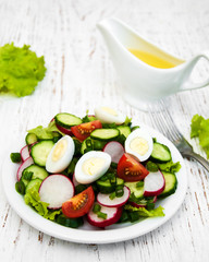 Spring salad with eggs, cucumbers and radish