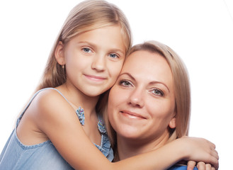 Portrait of a joyful mother and her daughter smiling at the came