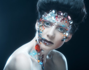 Closeup portrait of woman with artistic make-up.