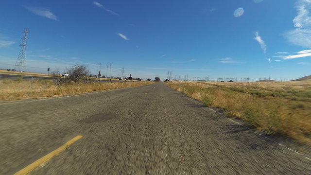 Rural Road Hyperlapse. A hyper-lapse of a vehicle POV as it drives down an old and run-down road in the rural countryside outside of Los Banos, California.