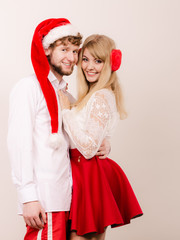 Smiling couple in santa claus hat. Christmas.