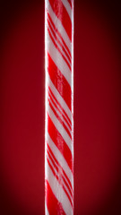 Striped candy cane on red