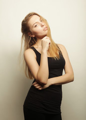 Fototapeta premium Beautiful woman with long blond hair. Fashion model posing at st