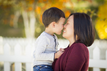Fototapeta premium Happy Chinese Mom Having Fun and Holding Her Mixed Race Little Boy.