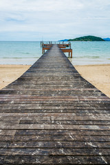 Fototapeta premium Image of long hardwood bridge over the sea