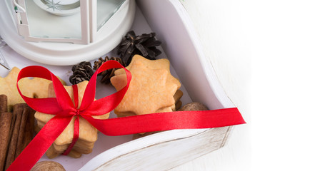 Christmas cookies tied with red ribbon in a wooden box. Space fo