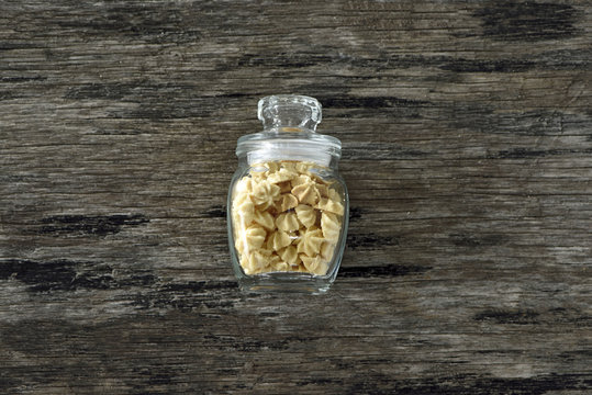 Butter cookie in glass bottle on wood background
