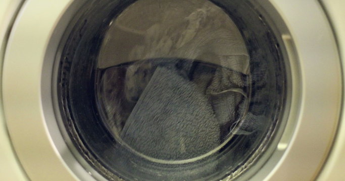 Clip of a high efficiency washing machine (side loader) washing laundry with a high shutter speed for reduced motion blur.