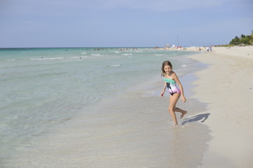 Happy girl have fun in the blue sea.