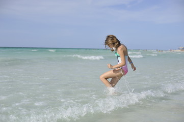 Happy girl have fun in the blue sea.