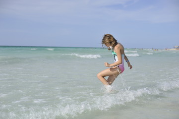 Fototapeta premium Happy girl have fun in the blue sea.