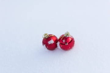 red christmas balls in fresh snow