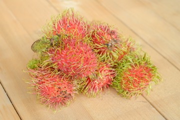 rambutan fruit on wood plank