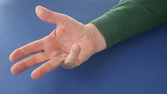 A man uses fingers to count to five.