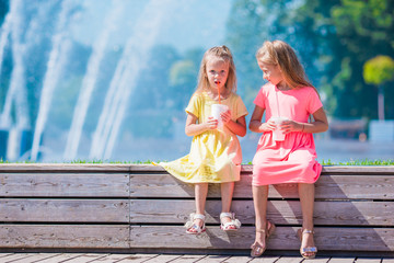 Little adorable kids eating ice cream on summer hot day