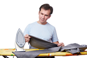 Happy man ironing his gray pants isolated