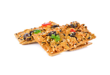 crispy cornflake pies with sesame and raisin on white background