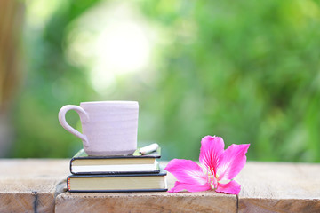 white cup and notebook with Purple Bauhinia