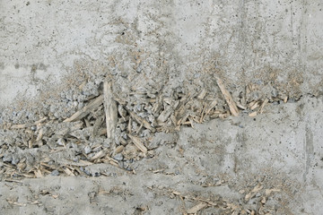 Background concrete wall shows a pattern made from rice straw