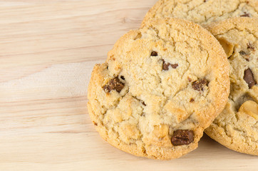 Chocolate chip cookies on wooden table.