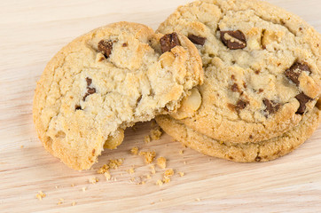 Chocolate chip cookies on wooden table.