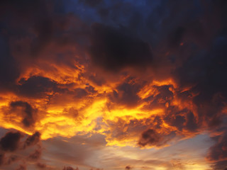 Dramatic sunset like fire in the sky with golden clouds