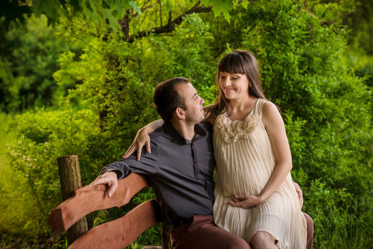 A pregnant woman and her partner sitting