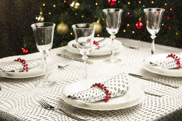 Christmas dinner table. Traditional Christmas decorations. Served table in a restaurant. Beautifully set table for Christmas Eve.