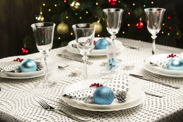 Christmas dinner table. Traditional Christmas decorations. Served table in a restaurant. Beautifully set table for Christmas Eve.