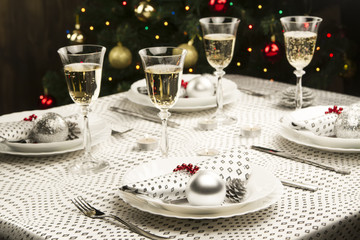 Christmas dinner table. Traditional Christmas decorations. Served table in a restaurant. Beautifully set table for Christmas Eve.
