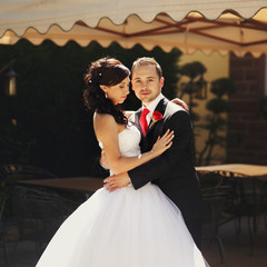 Handsome happy romantic groom and beautiful sensual bride in whi