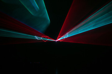 Expensive stylish laser show with light beams glow hearts at wed