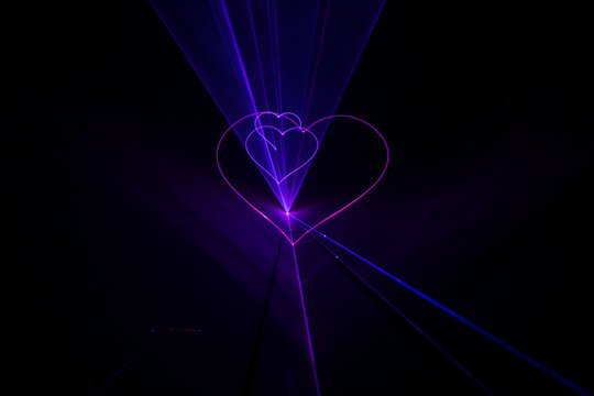 Expensive stylish laser show with light beams glow hearts at wed
