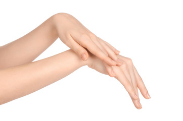 Beauty and Health theme: beautiful elegant female hand isolated on a white background in the studio, using cream advertisement, massage
