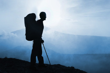 Silhouette of man trekker with backpack in the Crimean mountains, Ukraine