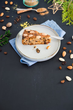 Piece of traditional scottish Dundee cake and its ingredients. Selective focus