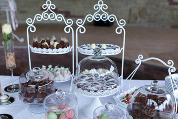Vintage elegant delicious dessert table with white stylish tableware