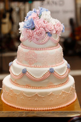 Obraz na płótnie Canvas Expensive, elegant vintage wedding cake with flowers and ornaments close-up