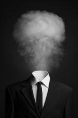 Surrealism and business topic: the smoke instead of a head man in a black suit on a dark background in the studio - obrazy, fototapety, plakaty
