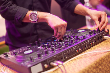 DJ mixing music on console at the night club