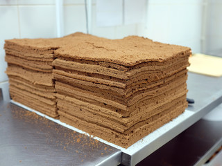 Empty chocolate shortcakes lay on the metal table. Сulinary workshop