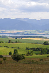 Fototapeta na wymiar Mountain and lake in distance landscape