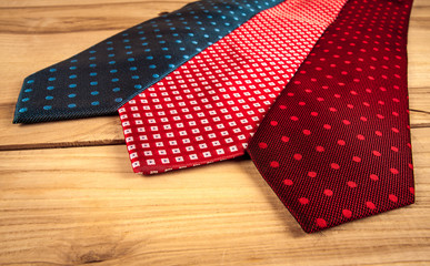 Fathers day composition of three ties hang on wooden wall backround