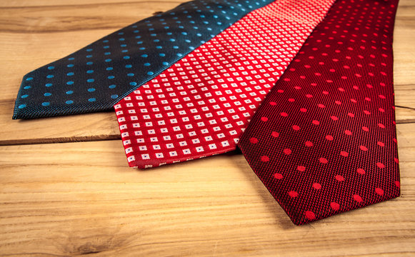Fathers day composition of three ties hang on wooden wall backround