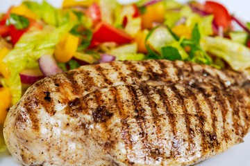 Close Up Grilled chicken breasts and vegetables.
