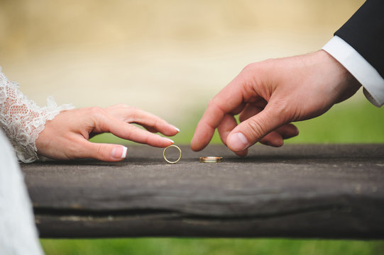 Newlyweds Playing with Rings